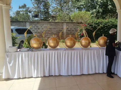 Kims Kitchen & Events lead coordinator overseeing outdoor banquet setup in Nairobi